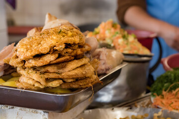 Pile of fried milanesas in a  market of Bolivia