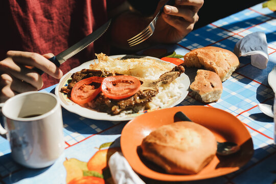 A person has breakfast in a traditional bolivian market from the Yungas region in Bolivia.