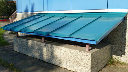 entrance to the basement under the blue roof