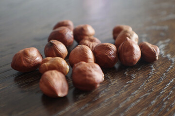 Heap of peeled hazelnuts. Hazel nuts. Organic peeled hazelnuts on Wooden Background. 