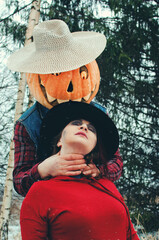 witch and a Halloween Scarecrow fight in the woods