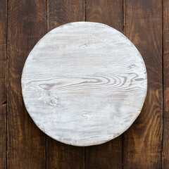round wooden plate on old wooden background