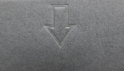 Down arrow on gray color aluminum sheet