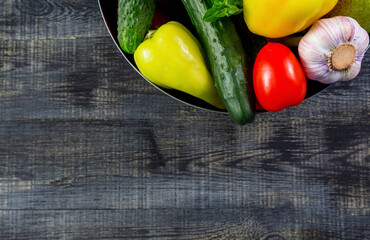 Pepper, garlic, tomato, cucumber, basil on a cutting board