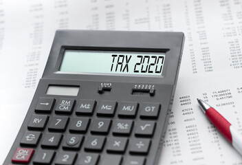 A calculator with the inscription TAX 2020 . Business profit concept