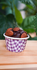 Dark chocolate almonds in a purple cup