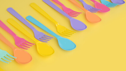 close up of plastic spoons on yellow background