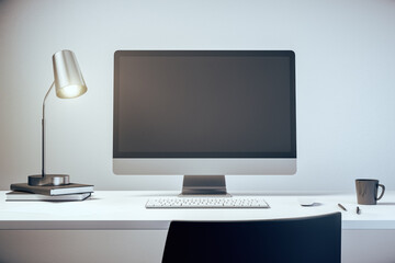 Modern computer with blank screen on white table with lamp and cup of coffee. 3D Rendering