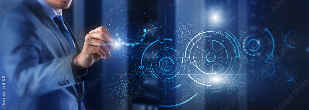 Wall mural man draws gears on virtual screen. blurred abstract engine room.