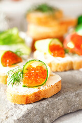 Sandwich with ricotta, a cucumber, caviar .