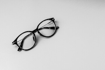  Glasses with transparent optical lenses . Black and white  . Copy space .