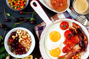 Breakfast including coffee, fried egg , becon. nut , muesli and bread . Top view