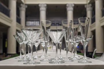 Various empty glasses on the table with blurred luxury interior