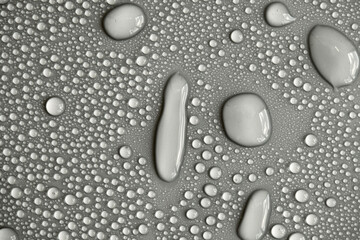Water drops on light background, top view, close-up, macro. Great background with natural water drops and natural light