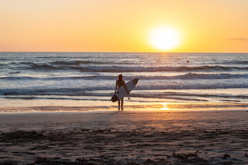Surfer Watching Crashing Waves at Sunset Beach Costa Rica - obrazy, fototapety, plakaty