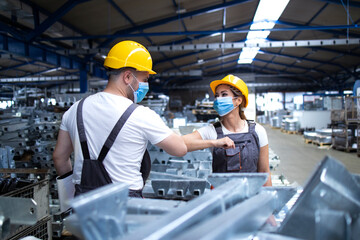Workers greeting each other with elbow bump due to global corona virus pandemic and danger of...
