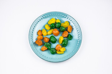 Candied kumquat on a turquoise plate.