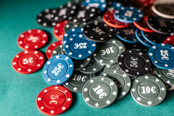 gaming chips for gambling card games and poker on the background of a green table