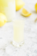 Italian traditional liqueur limoncello with lemon
