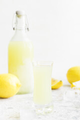Italian traditional liqueur limoncello with lemon