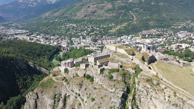 Picturesque autumn landscape with imposing medieval citadel on hilltop on background with French fortified township of Briancon. High quality 4k footage