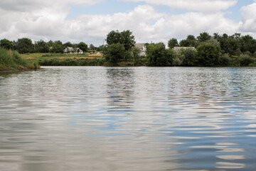 small lake in a village in a meadow