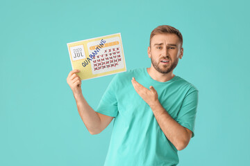 Troubled man holding calendar with written word QUARANTINE against color background