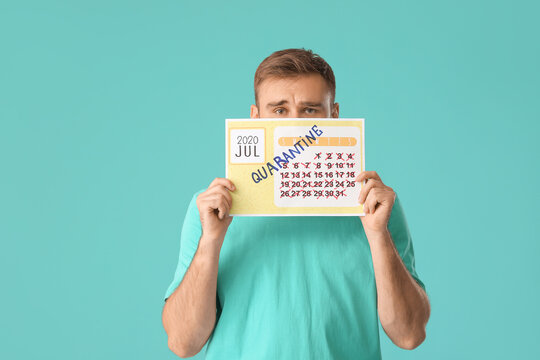 Sad man holding calendar with written word QUARANTINE against color background