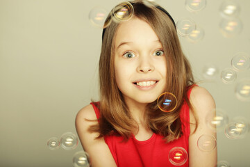 little girl blowing soap bubbles