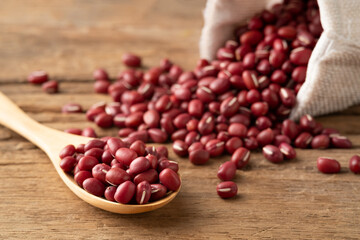 Red Beans in wooden spoon on wood plate background