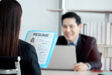 Fototapeta premium Job interview concept, woman holding her resume paper for giving to businessman manager, candidate giving CV to human resources officer