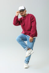 Male hip-hop dancer on grey background