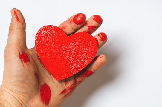 blood heart in hand on white background, concept, mock up, text space