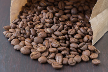 a mass of coffee beans in a paper bag