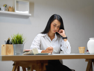 Female entrepreneur working on office desk in home office room