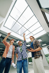 Construction engineers gathered to discuss how to replace old massive roof window