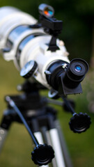 Plakat Telescope to nature. A retired man looks at the moon through a telescope. Retired hobby. Blurred background.