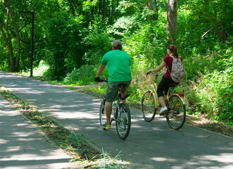 Fototapeta premium A man and a woman are riding bicycles in a pair.