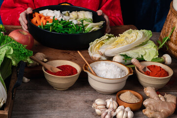 Fresh ingredients and vegetables Placed in the table For making Kimchi Which contains ingredients such as ginger, garlic, salt, onion, sugar, gochugaru (Korean chili). Kimchi is a healthy food.