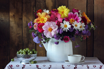 bouquet of garden flowers in a white teapot