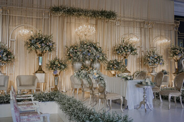 wedding stage decoration with fabric and flower bouquet. flower decoration on wedding backdrop