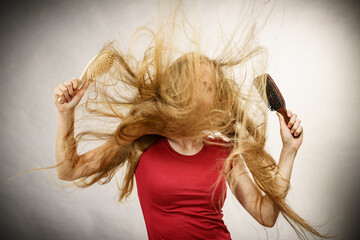 Girl blowing hair with comb brush