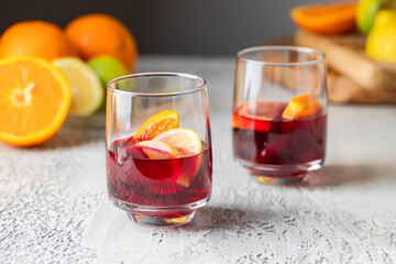 Two glasses with Refreshment acholic drink  sangria making with red wine, orange and other fruit. Famous Spanish summer beverage