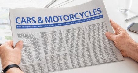 Man reading newspaper with the headline Cars and Motorcycles