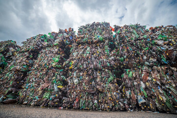 mountains of plastic bottles in a landfill for recycling
