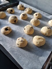 Home-made raisin buns with longs shadows in a kitchen.