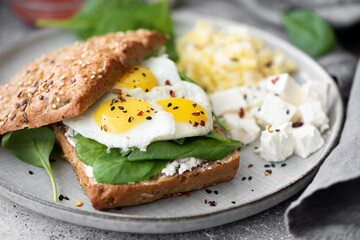 sandwich with quail eggs, curd cheese and spinach