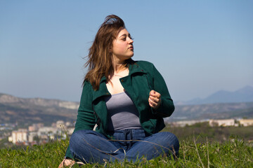 2. Curvy girl on the grass in lotus position. Looks to the right.