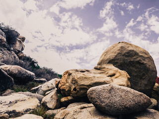 Huge yellow strange stone near sea. Alien planet landscape, rock formations. Dramatic toned photo...