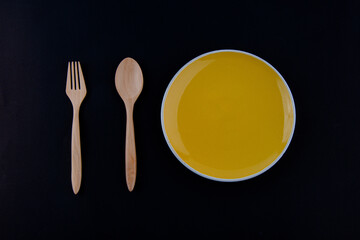  Wooden Spoon and plate on black background.